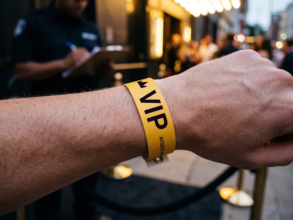 Gold VIP wristband worn at a venue's VIP entrance